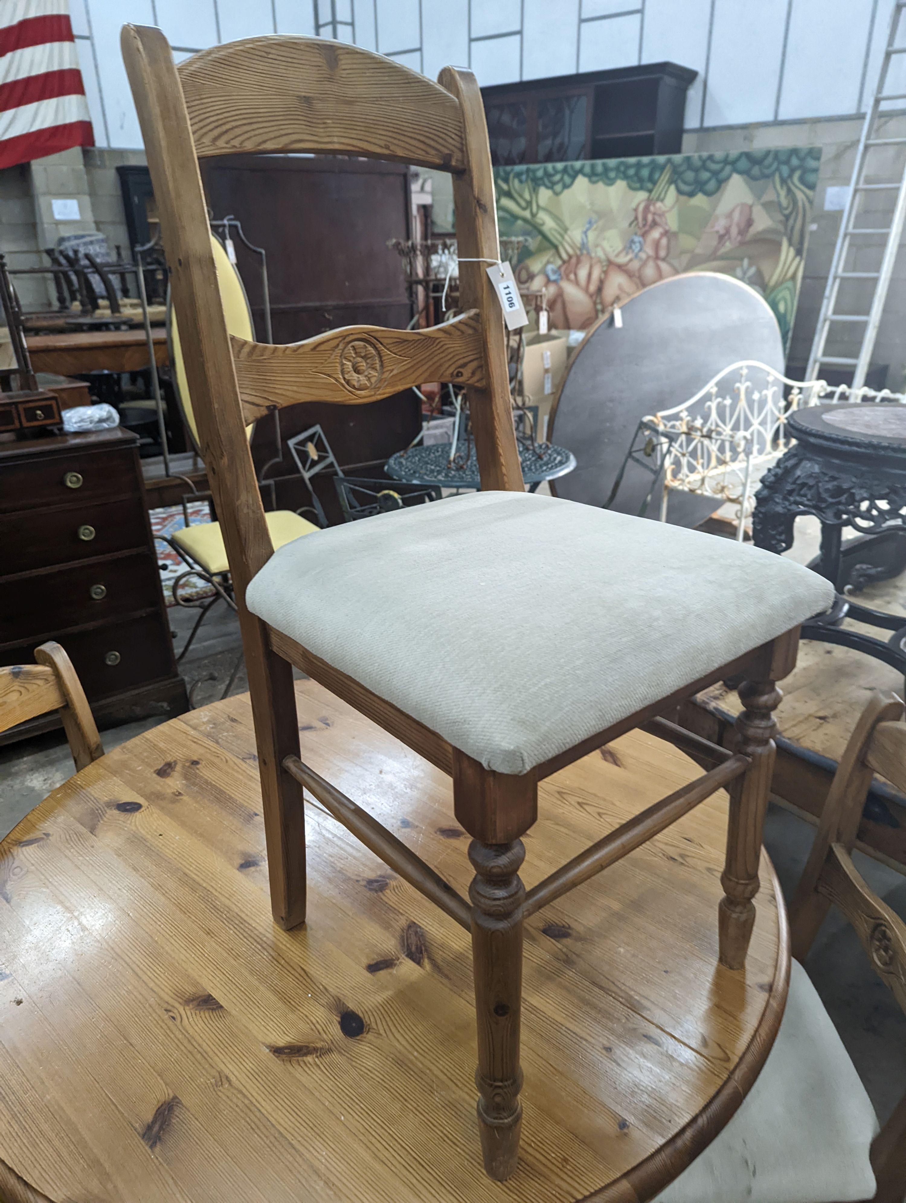 A reproduction circular pine breakfast table, diameter 105cm, height 77cm together with five pine dining chairs